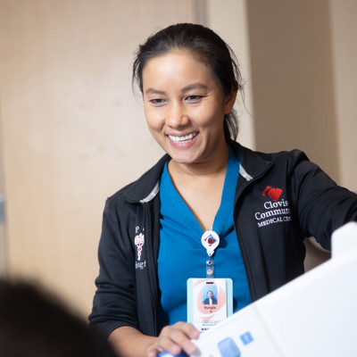a person smiling at a machine