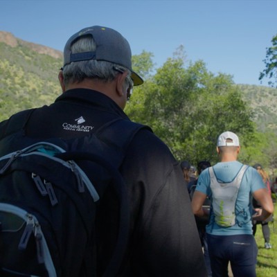 a group of people walking in the woods