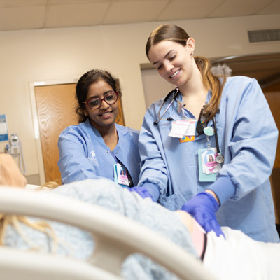 a group of women in scrubs in a hospital room