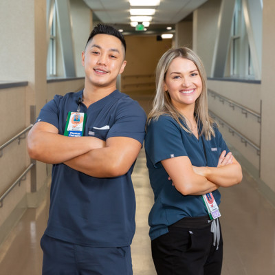 a person and person standing in a hallway