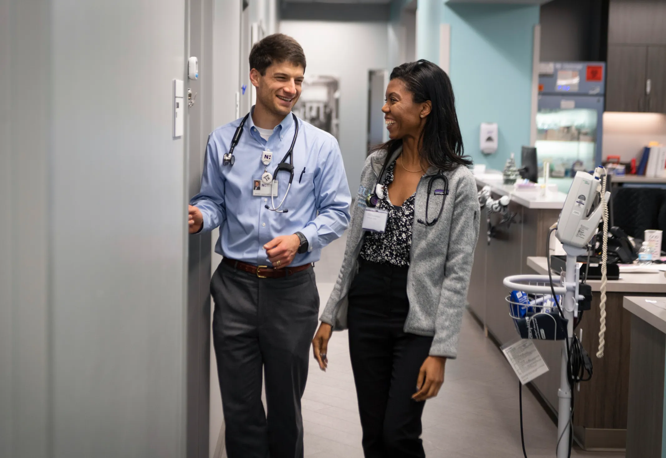 2 Novant Health providers chat and walk down a clinic hallway