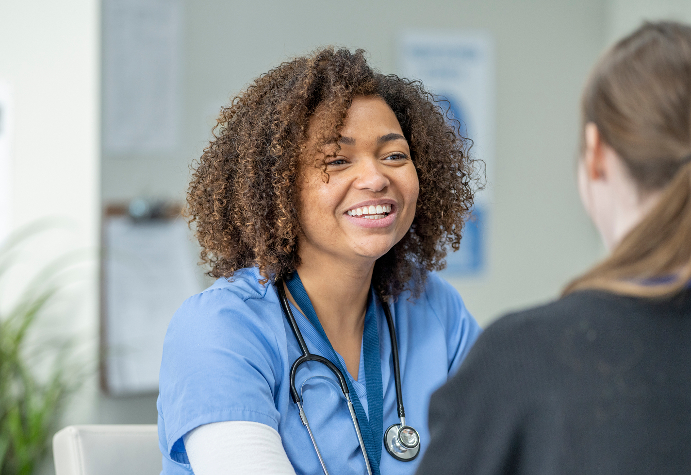 An APP smiles with her patient