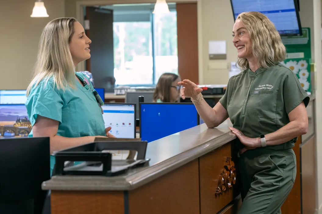 Novant Health ob-gyn Dr. White smiles as she chats with a nurse