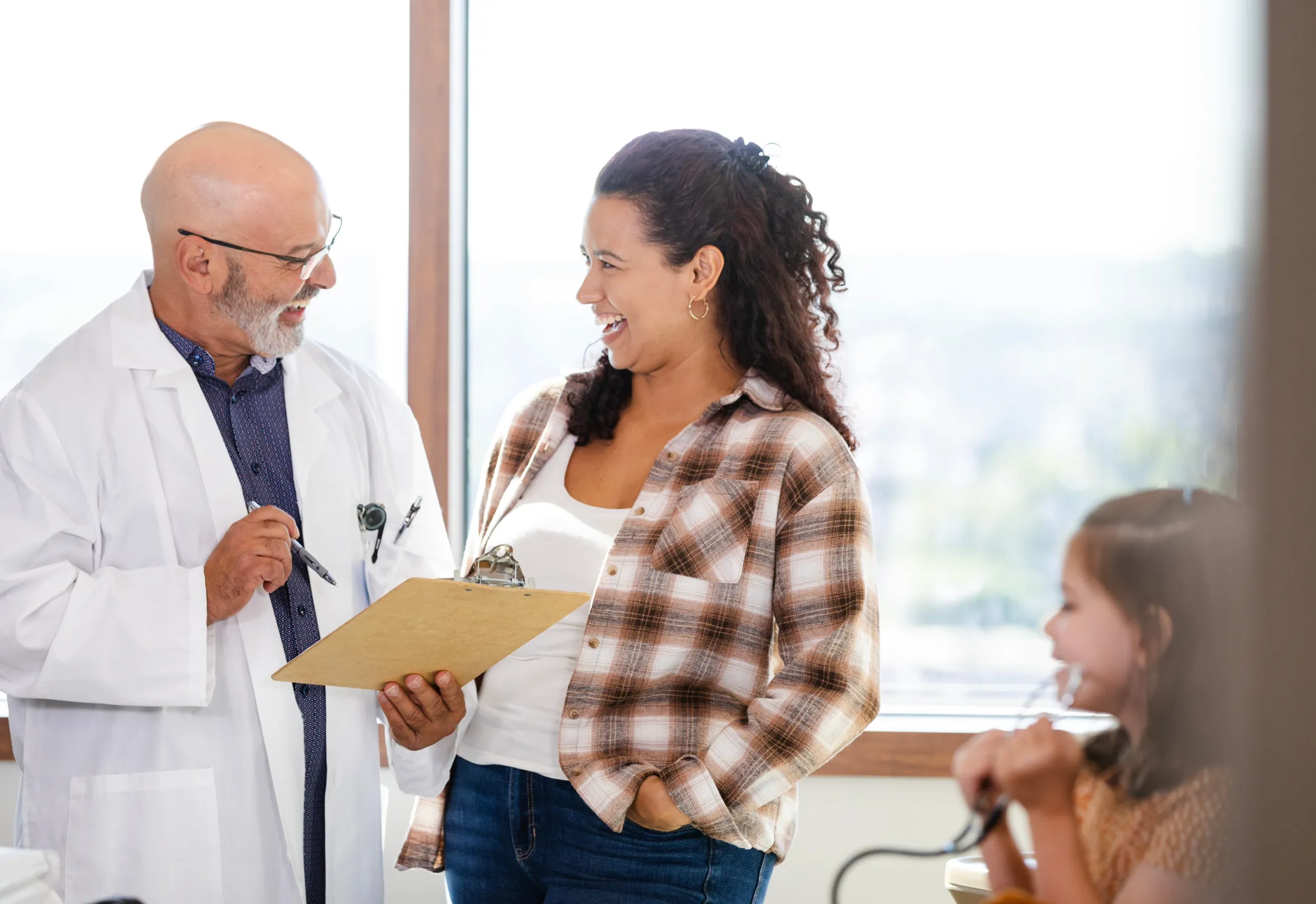 A doctor laughs with his patient
