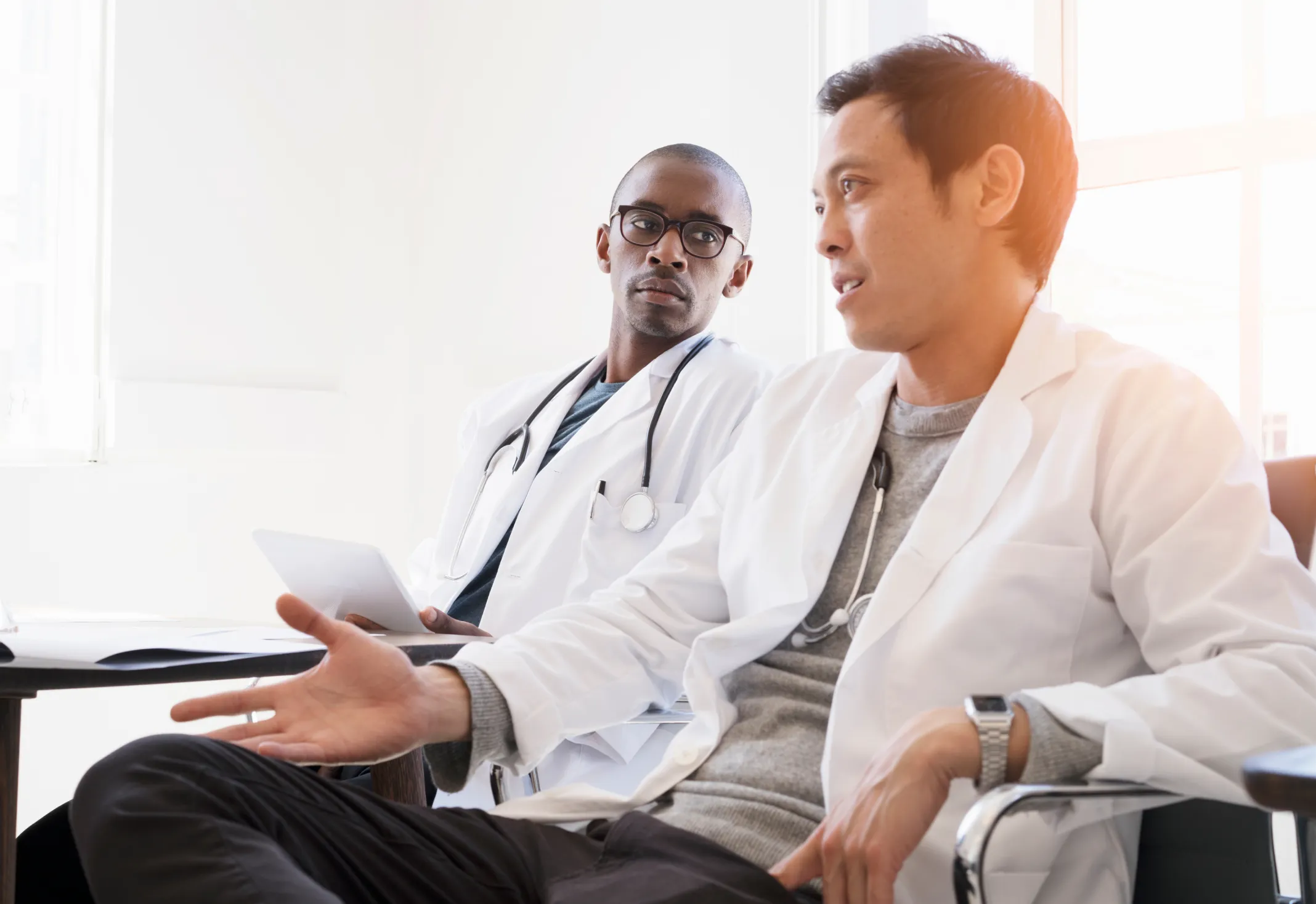 Two young doctors being listened to