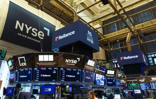 NYSE trading floor with Reliance signs and market screens