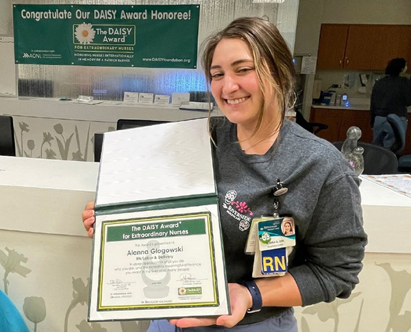 A nurse holds a DAISY Award