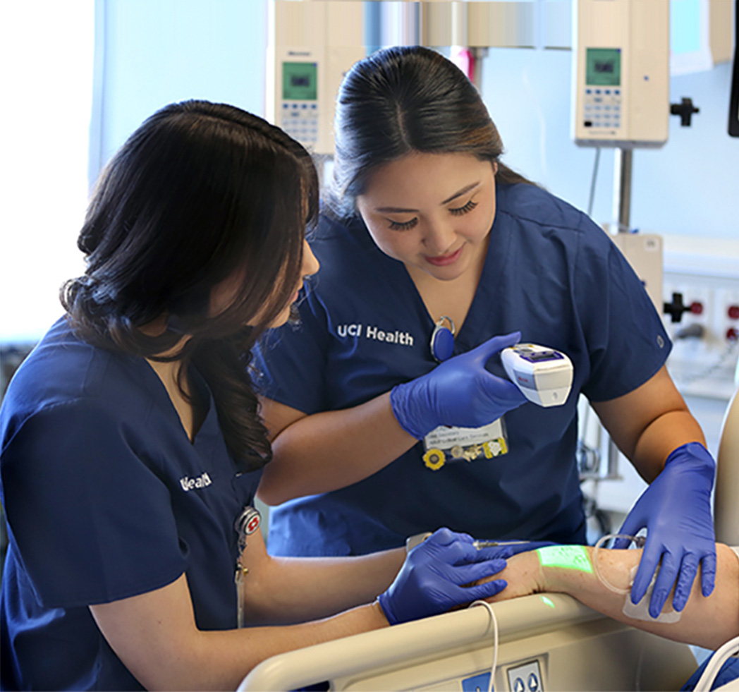 Two female nurses checking a patient